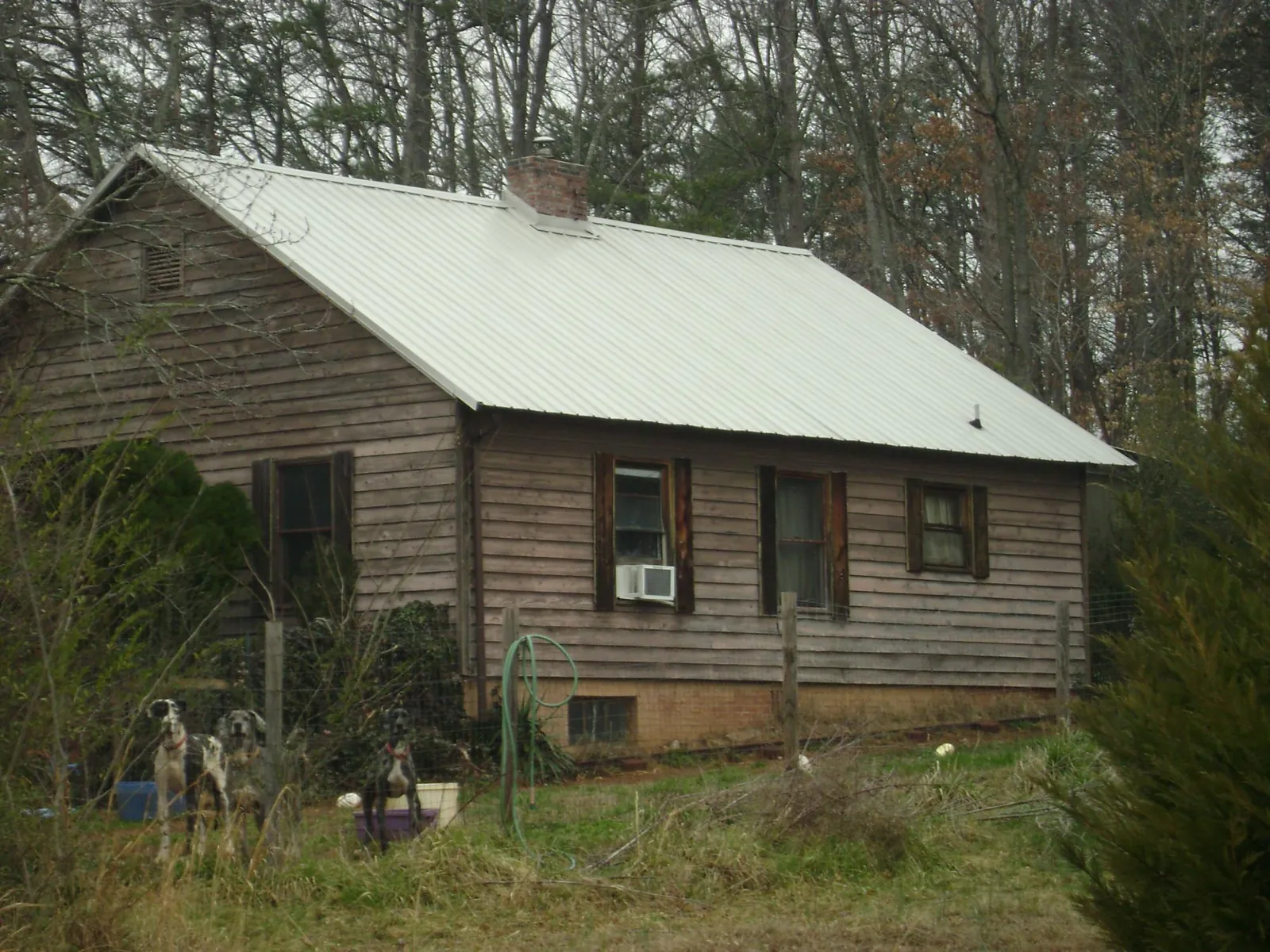 White metal roof on an old wood sided farmhouse, from a Metal Roof Installation job in West Sayville